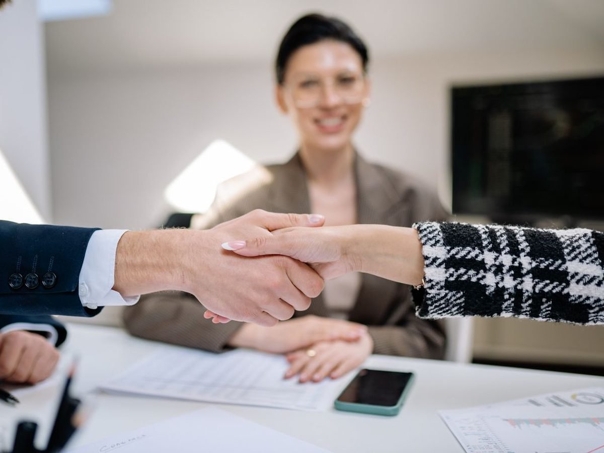Two business partners shaking hands after agreeing a partnership