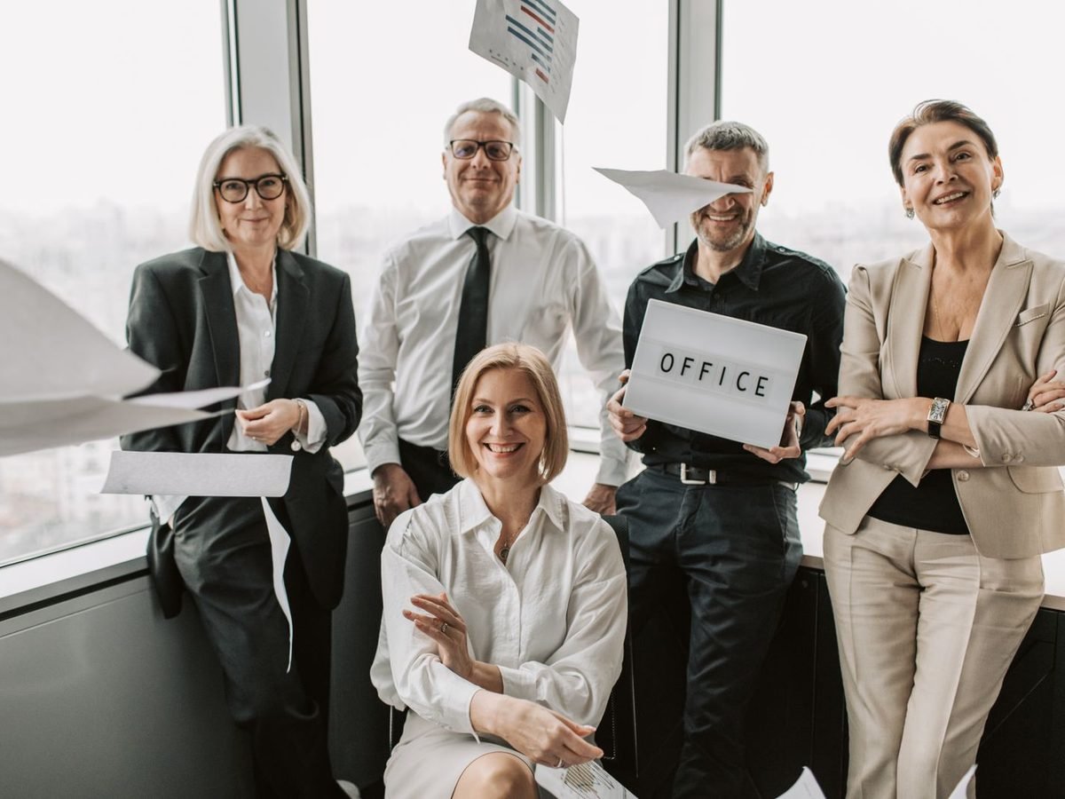 Cheerful team celebrating together in a bright office